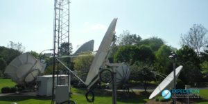 Antenna next to field instruments in a grassy field